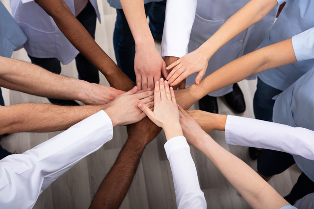 Elevated View Of Doctors Stacking Hands